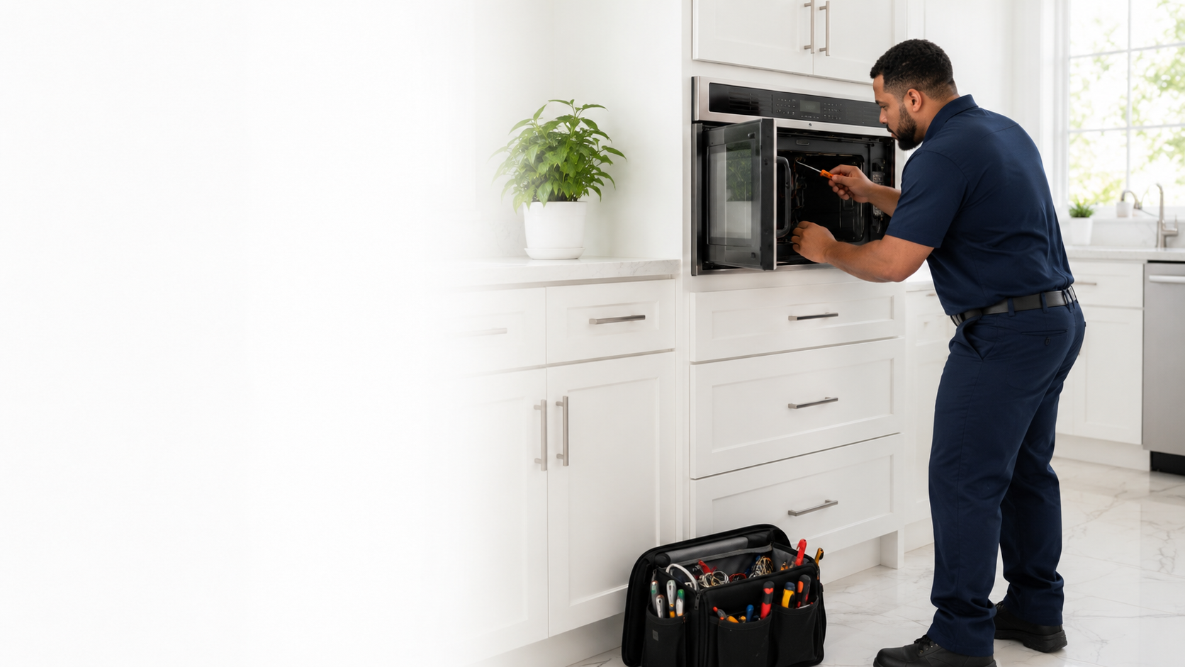 Technician repairing a built-in microwave